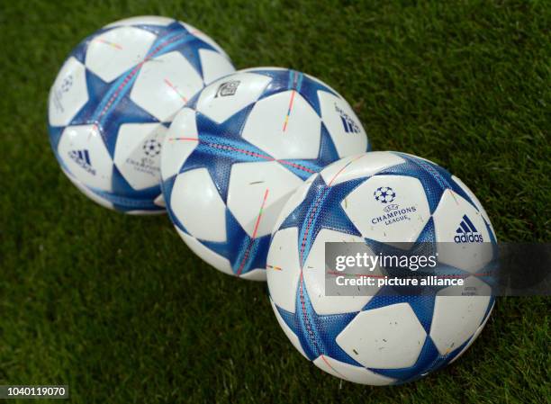 Three soccer balls featuring the UEFA Champions League logo pictured prior to the UEFA Champions League Group B soccer match between VfL Wolfsburg...