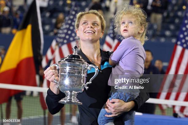 Kim Clijsters of Belgium and daughter Jada pose with the championship trophy after Clijsters defeated Vera Zvonareva of Russia during their women's...