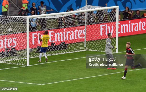 Toni Kroos of Germany scores a goal as Brazil's goalkeeper Julio Cesar is beaten during the FIFA World Cup 2014 semi-final soccer match between...