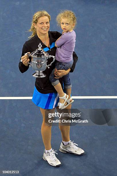 Kim Clijsters of Belgium and daughter Jada pose with the championship trophy after Clijsters defeated Vera Zvonareva of Russia during their women's...