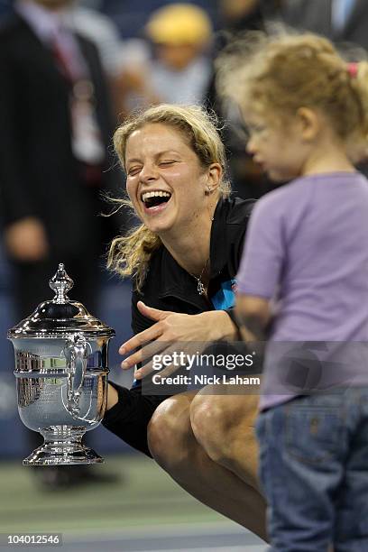 Kim Clijsters of Belgium holds the championship trophy as she celebrates with her daughter Jada after Clijsters defeated Vera Zvonareva of Russia...