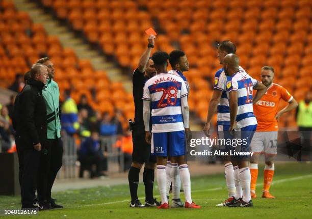 Jordan Cousins of Queens Park Rangers is sent off by referee Tim Robinson as Steve McClaren the manager of Queens Park Rangers looks on during the...