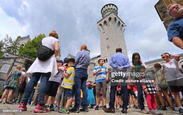 Tourists stand in the inner courtyard of Neuschwanstein Castle near Fuessen, Germany, 05 July 2016. A couple from China has been missing since their...