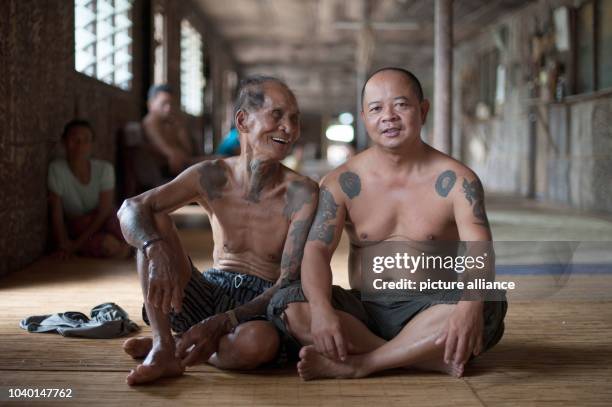 Two Iban men are sitting inside a traditional Iban longhouse near Lubok Antu, Malaysia, on . Photo: Sebastian Kahnert - NO WIRE SERVICE - | usage...