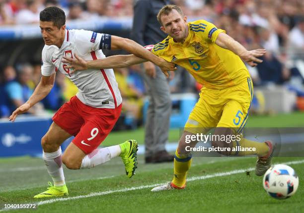 Ukraine's Olexandr Kucher and Poland's Robert Lewandowski challenge for the ball during the UEFA Euro 2016 Group C preliminary round soccer match...