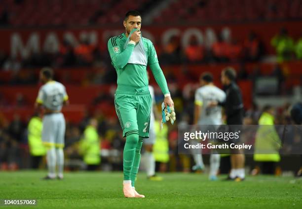 Sergio Romero of Manchester United looks dejected as he leaves the pitch after recieving a red card for a hand ball during the Carabao Cup Third...