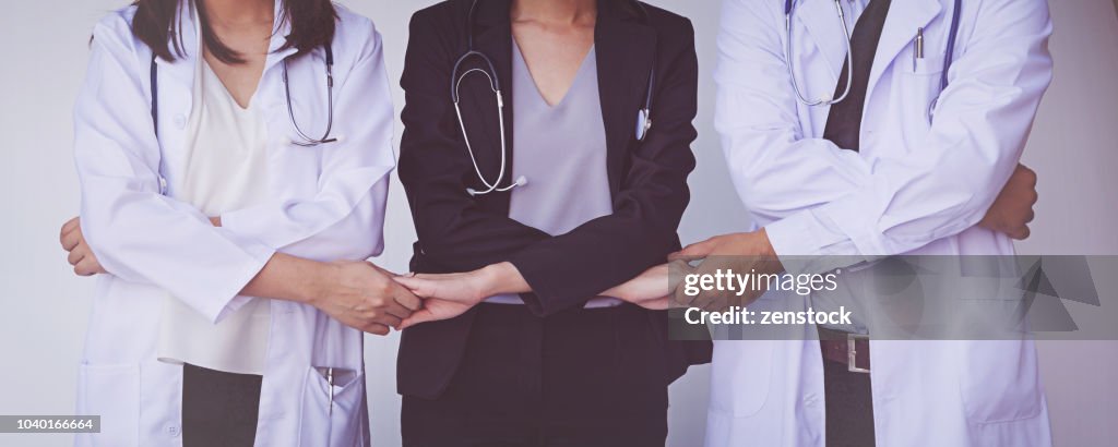 Doctors and Nurses coordinate hands. Concept Teamwork