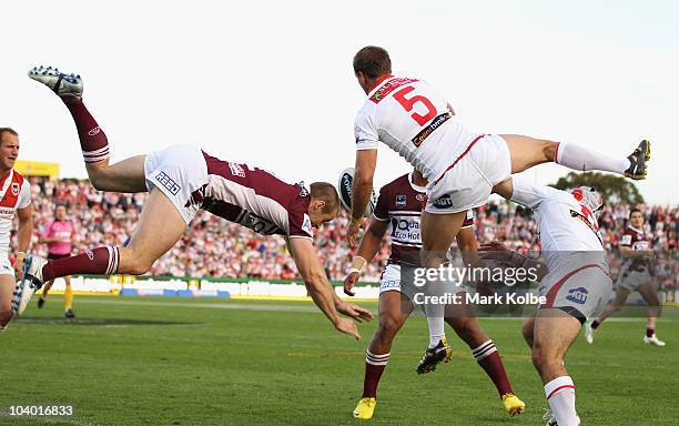 Michael Robertson of the Eagles and Jason Nightingale of the Dragons compete for the ball during the NRL Fourth Qualifying Final match between the St...
