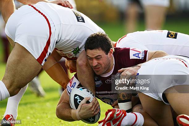 Chris Bailey of the Sea Eagles is tackled during the NRL Fourth Qualifying Final match between the St George Illawarra Dragons and the Manly...