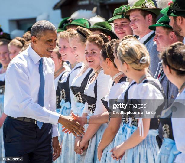 President Barack Obama talks to members of the public in traditional dress in Kruen, Germany, 07 June 2015 as he joins with German Chancellor Angela...