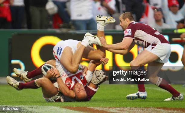 Matt Cooper of the Dragons is up-ended as he scores a try during the NRL Fourth Qualifying Final match between the St George Illawarra Dragons and...