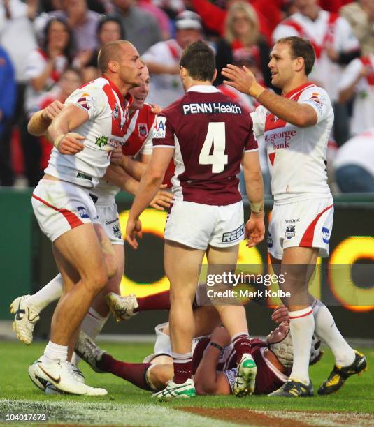 Matt Cooper of the Dragons is congratulated by his team mates after he scored a try during the NRL Fourth Qualifying Final match between the St...
