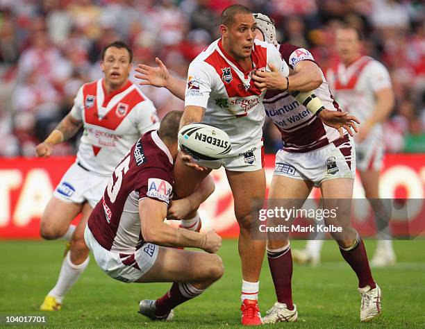 Jeremy Smith of the Dragons gets a pass away as he is tackled during the NRL Fourth Qualifying Final match between the St George Illawarra Dragons...