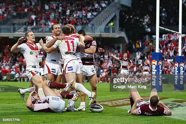Matt Cooper of the Dragons celebrates with team mates after scoring his first try during the NRL Fourth Qualifying Final match between the St George...