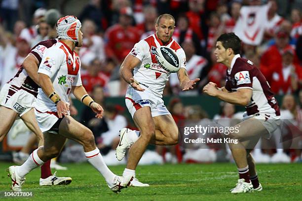 Matt Cooper of the Dragons takes an offload from Jamie Soward to score his second try during the NRL Fourth Qualifying Final match between the St...