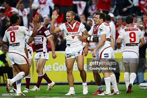 Matt Cooper of the Dragons celebrates with team mates after scoring his second try during the NRL Fourth Qualifying Final match between the St George...