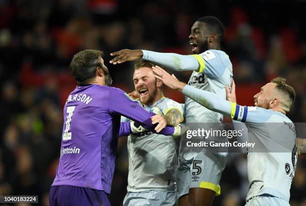 Scott Carson of Derby County celebrates with teammates after he saves Manchester United's eighth penalty from Phil Jones during a penalty shoot out,...