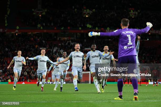 Derby players celebrate with Derby goalkeeper Scott Carson after his penalty save gifted them victory during the Carabao Cup Third Round match...