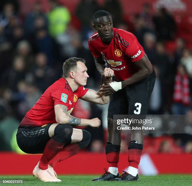 Phil Jones of Manchester United is consoled by Eric Bailly after missing his penalty during the shoot out during the Carabao Cup Third Round match...