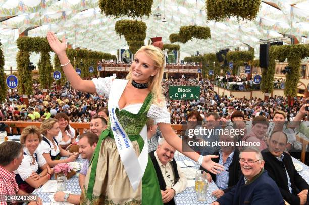 Wiesn Playmate Denise Cotte in the Hofbraeu Tent during the opening of Oktoberfest in Munich, Germany, 20 September 2014. A one-litre stein of...