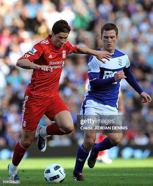 Liverpool's Spanish player Fernando Torres vies for the ball against Birmingham City's Craig Gardner during the Premiership football match at St....