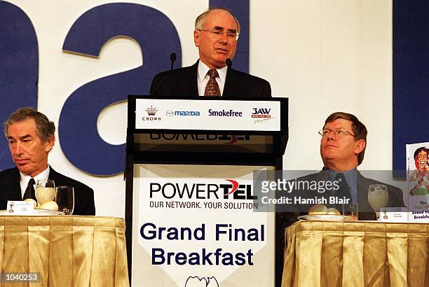 Prime Minister of Australia John Howard speaks to the crowd whilst Ron Evans and Wayne Jackson CEO of the AFL look on during the North Melbourne...