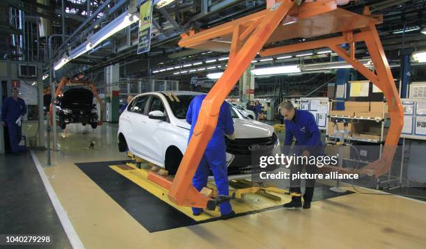 Workers on the Lada production line in the Russian car manufacturer AvtoVaz's factory in the industrial city of Tolyatti roughly 1,000 kilometers...