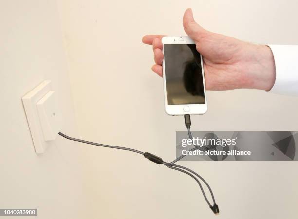 Xing founder and building contractor of the 'Apartimentum,' Lars Hinrichs, charges his smartphone in the stairwell in the 'Apartimentum' in...