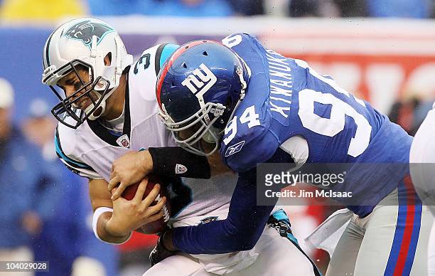 Matt Moore of the Carolina Panthers is sacked in the fourth quarter by Mathias Kiwanuka of the New York Giants on September 12, 2010 at the New...