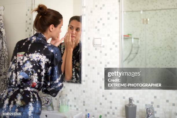 femme dans la salle de bains - irritation cutanée photos et images de collection