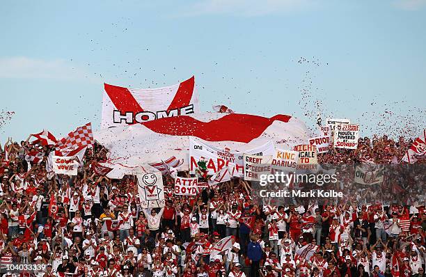 The Dragons supporters in the crowd cheers as their team takes the field during the NRL Fourth Qualifying Final match between the St George Illawarra...