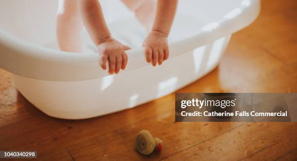 baby in bath tub - baby bath toys stock pictures, royalty-free photos & images