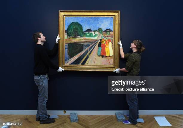 Workers at the newly opened Barberini Art Museum hang the Norwegian painter Edvard Munch's 'Girl on a Bridge' in Potsdam, Germany, 13 January 2017....