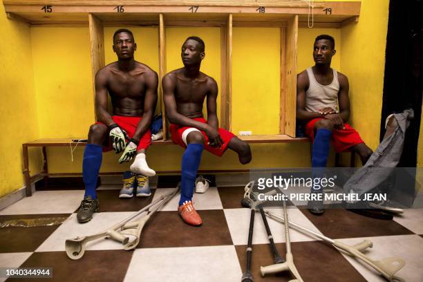 Some players of the Haitian football selection of players with amputated limbs gather in the locker room of the Parc Sainte-Thérèse in Pétion-ville...