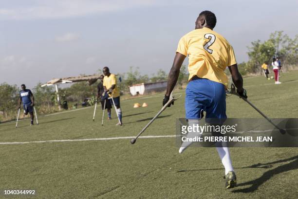 Training session of the Haitian football selection of players with amputated limbs is seen on September 14, 2018 in Croix-des Bouquets, Haiti before...