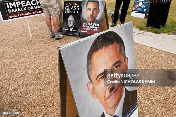 Picture of US President Barack Obama with a Hitler-like mustache is seen at a stand of controversial politician Lyndon LaRouche's movement during a...