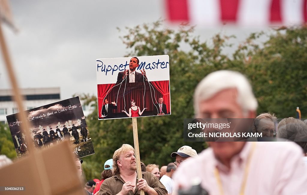 A demonstrator carries a sign depicting