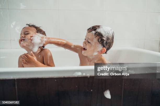brothers playing in the bathtub - brothers imagens e fotografias de stock
