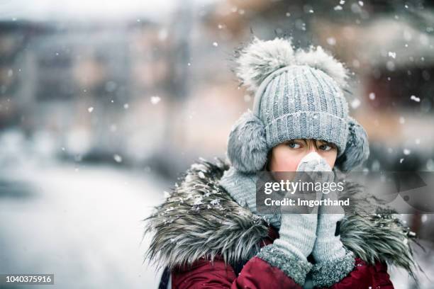 teenage girl blowing nose on winter day - winter weather imagens e fotografias de stock