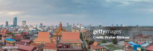 phnom penh, elevated skyine along tonle sap river, dusk - phnom penh stock pictures, royalty-free photos & images