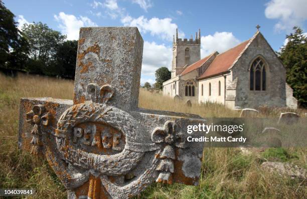 The sun illuminates a grave stone in the churchyard of St Giles in the village of Imber on September 12, 2010 near Warminster, England. The village...