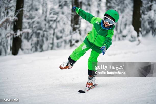 little boy skiing on one ski - skiing accident stock pictures, royalty-free photos & images