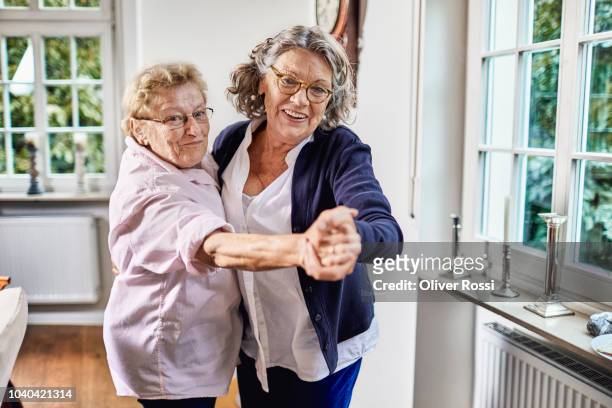 happy senior friends dancing together - senior women dancing stock pictures, royalty-free photos & images