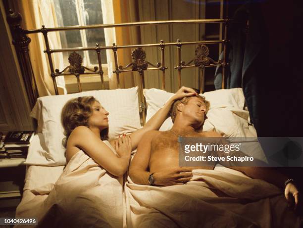 View of American actors Barbra Streisand and Robert Redford as they lie in bed in a scene from the film 'The Way We Were' , Los Angeles, California,...