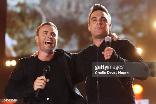 Gary Barlow and Robbie Williams perform at the Help The Heroes Concert 2010 held at Twickenham Stadium on September 12, 2010 in London, England.
