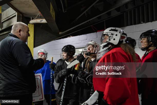 having a quick team meeting - hockey coach stock pictures, royalty-free photos & images