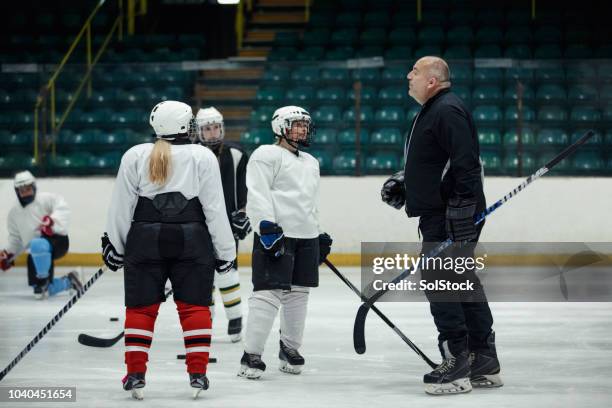 directing the team during practice - hockey talks stock pictures, royalty-free photos & images