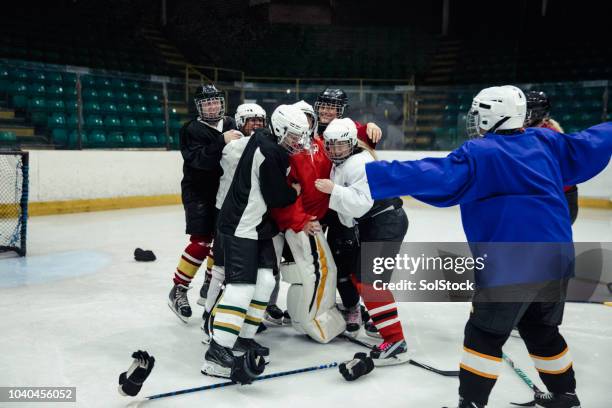 group of ice hockey players celebrating - ice hockey celebration stock pictures, royalty-free photos & images