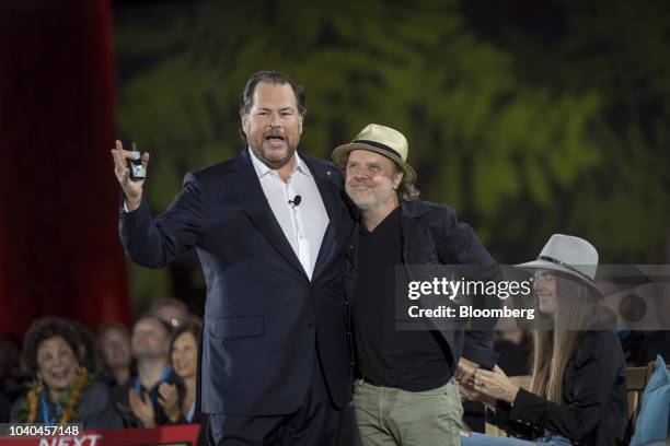 Marc Benioff, chairman and co-chief executive officer of Salesforce.com Inc., left, speaks as Lars Ulrich, drummer with the band Metallica, listens...