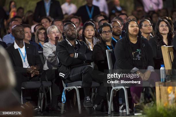 Will.I.Am, chief creative officer of 3D Systems Corp., center, listens to a presentation during the opening keynote at the DreamForce conference in...